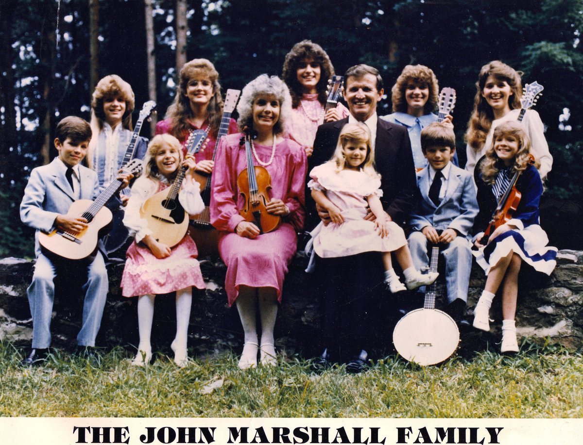 The John Marshall Family poster from Wisconsin, 1987: the family seated outdoors with their instruments above the printed name The John Marshall Family